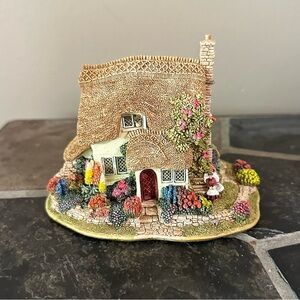 Charming Cottage Figurine with Floral Accents